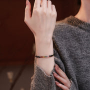 Obsidian and tourmaline bracelet worn on wrist