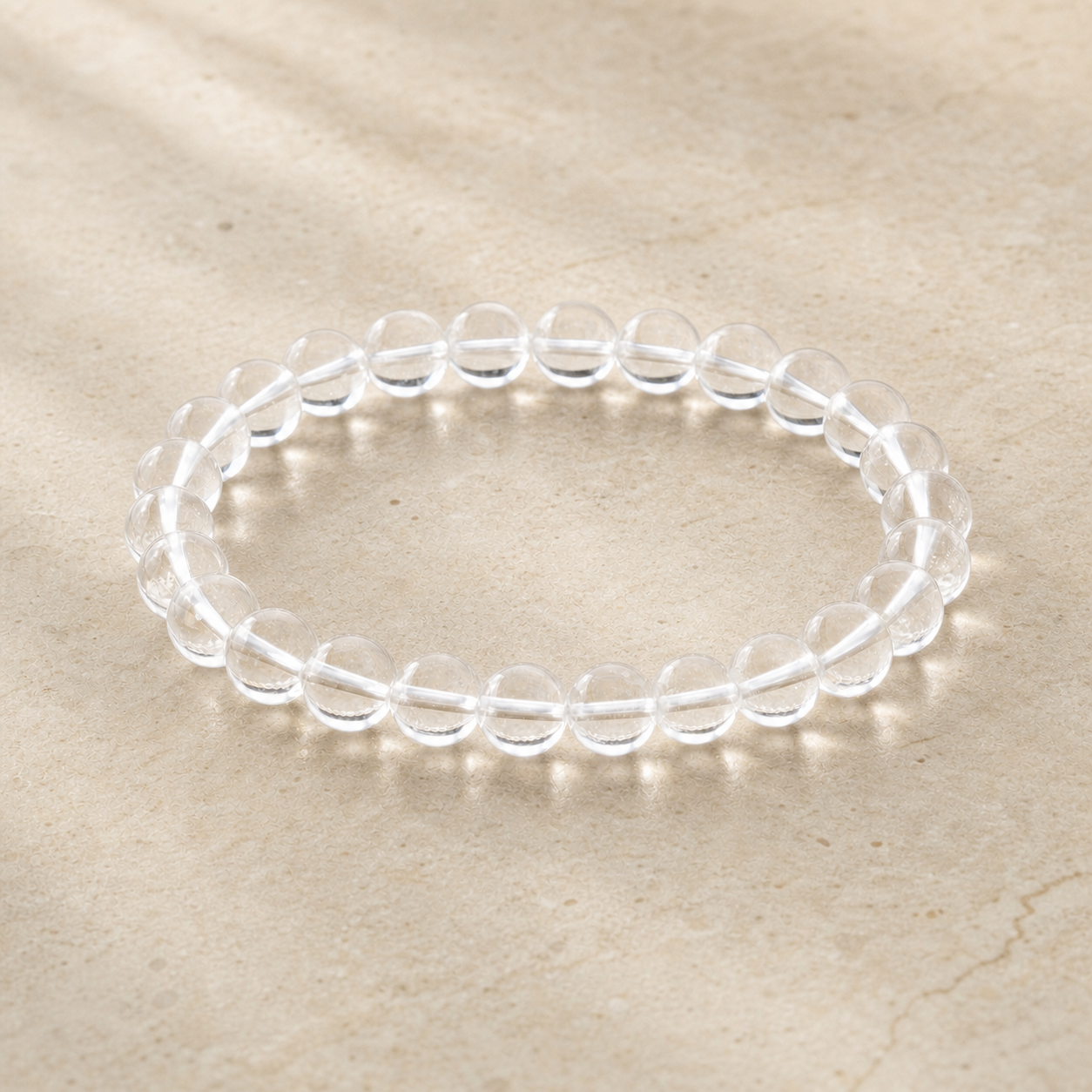 Clear quartz bracelet on warm ivory stone