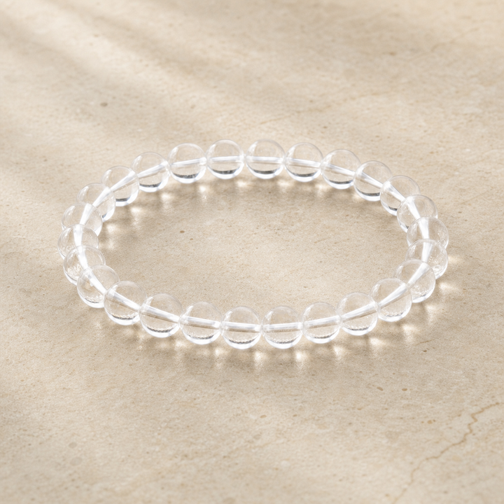 Clear quartz bracelet on warm ivory stone