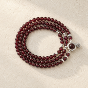 Top-down view of the garnet lotus heart wrap bracelet