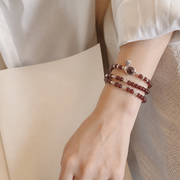 Garnet lotus heart wrap bracelet worn on the wrist