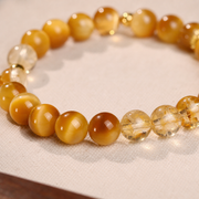 Macro detail of golden tiger eye and yellow crystal beads