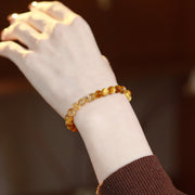 Golden tiger eye crystal bracelet worn on the wrist