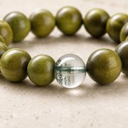 Close-up of green phantom crystal and green sandalwood bead grain