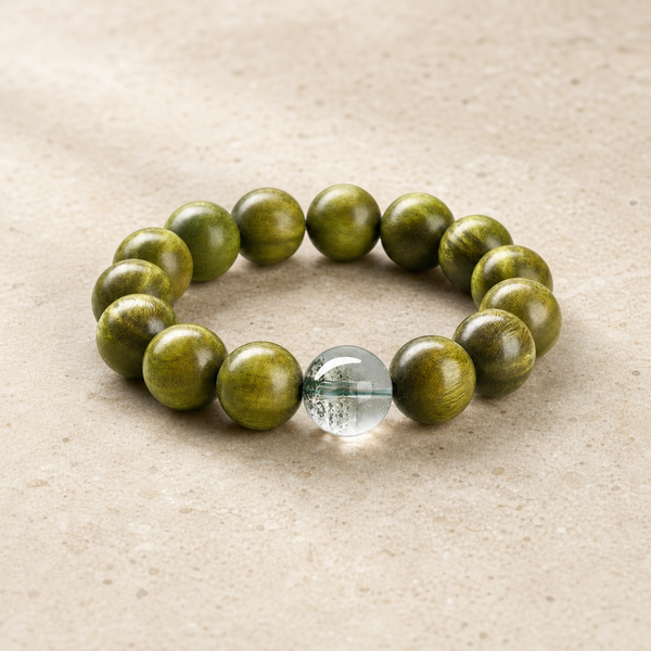 Green sandalwood and green phantom bracelet on warm ivory stone