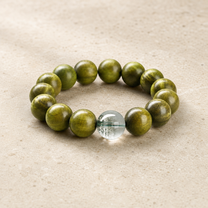 Green sandalwood and green phantom bracelet on warm ivory stone