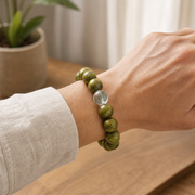 Green sandalwood bracelet worn on the wrist to show 10 mm bead scale