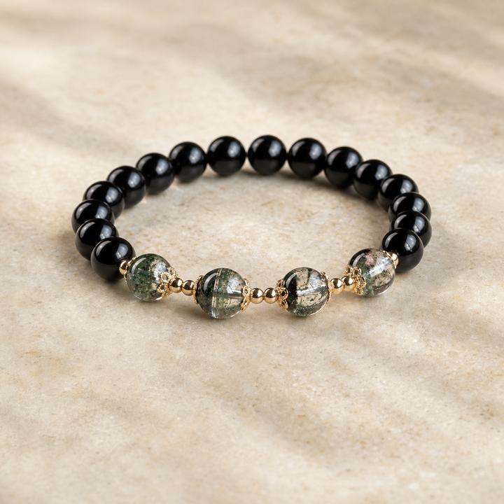 Obsidian and green phantom bracelet on warm ivory stone