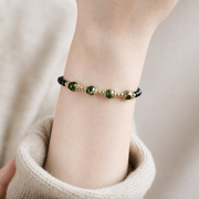 Obsidian and green phantom bracelet worn on the wrist