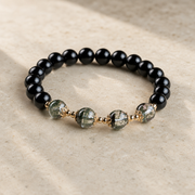 Three-quarter studio view of the obsidian and green phantom bracelet